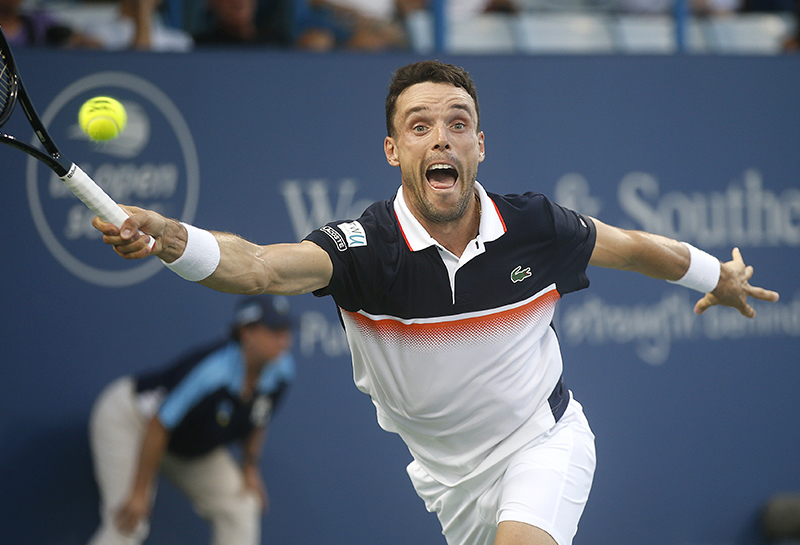 Roberto Bautista hits the ball while playing Frances Tiafoe at the Western and Southern Open at the Lindner Tennis Center in Mason on Wednesday, August 14, 2019.  The tournament started on September 18, 1899 and is the oldest tennis tournament in the United States played in its original city.  Photo  by Leigh Taylor