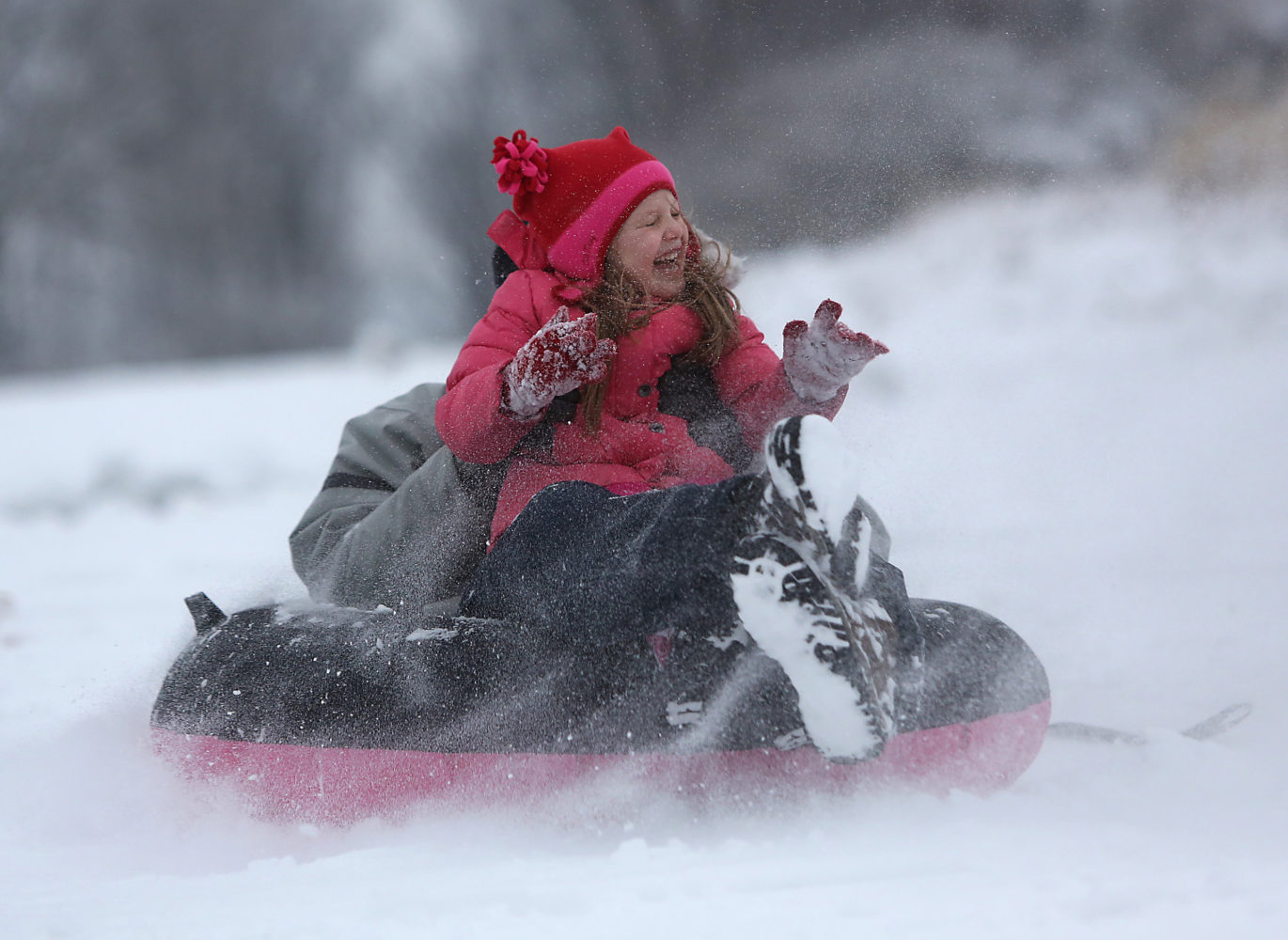 snowlt  March 6, 2013  Eva Heikenfeld, 5, from Mt. Lookout, has a big smile on her face as she goes sled riding with her dad Shane at Ault Park on Wednesday, March 6, 2013.     The Enquirer/Leigh Taylor