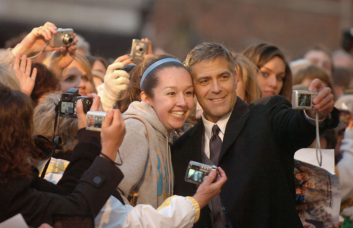 LEATHERHEADS  MARCH 24, 2008  Movie star George Clooney takes a photo with fan Ariana Bowles, from West Union, Ohio, on the red carpet at the feature of his movie Leatherheads at the Washington Opera Theatre in Maysville, Kentucky on Monday evening.  A crowd of several hundred greeted the stars of the movie.  The Enquirer/Leigh Taylor